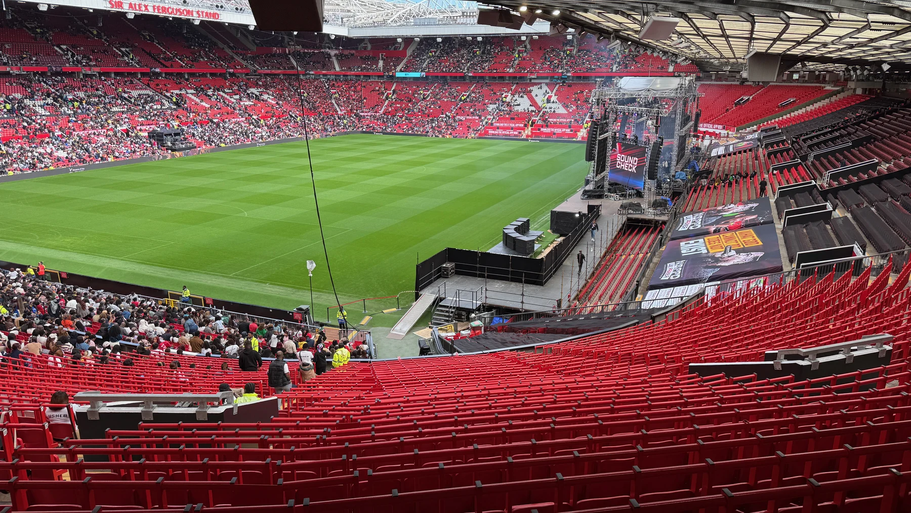 Wide view across Old Trafford with the event audience in the stands and the NSPPD temporary stage at pitch side